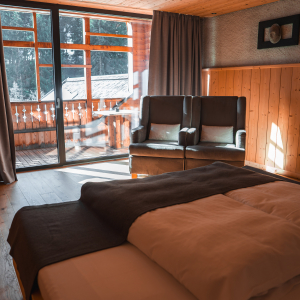 cozy-hotel-room-with-wooden-interior-balcony-italian-alps